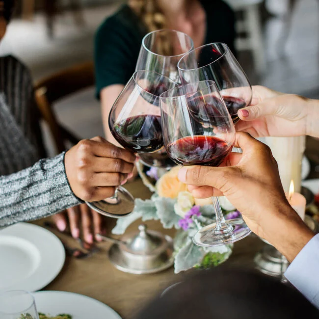 people-clinging-wine-glasses-together-in-restauran-2023-11-27-05-19-55-utc-650x650